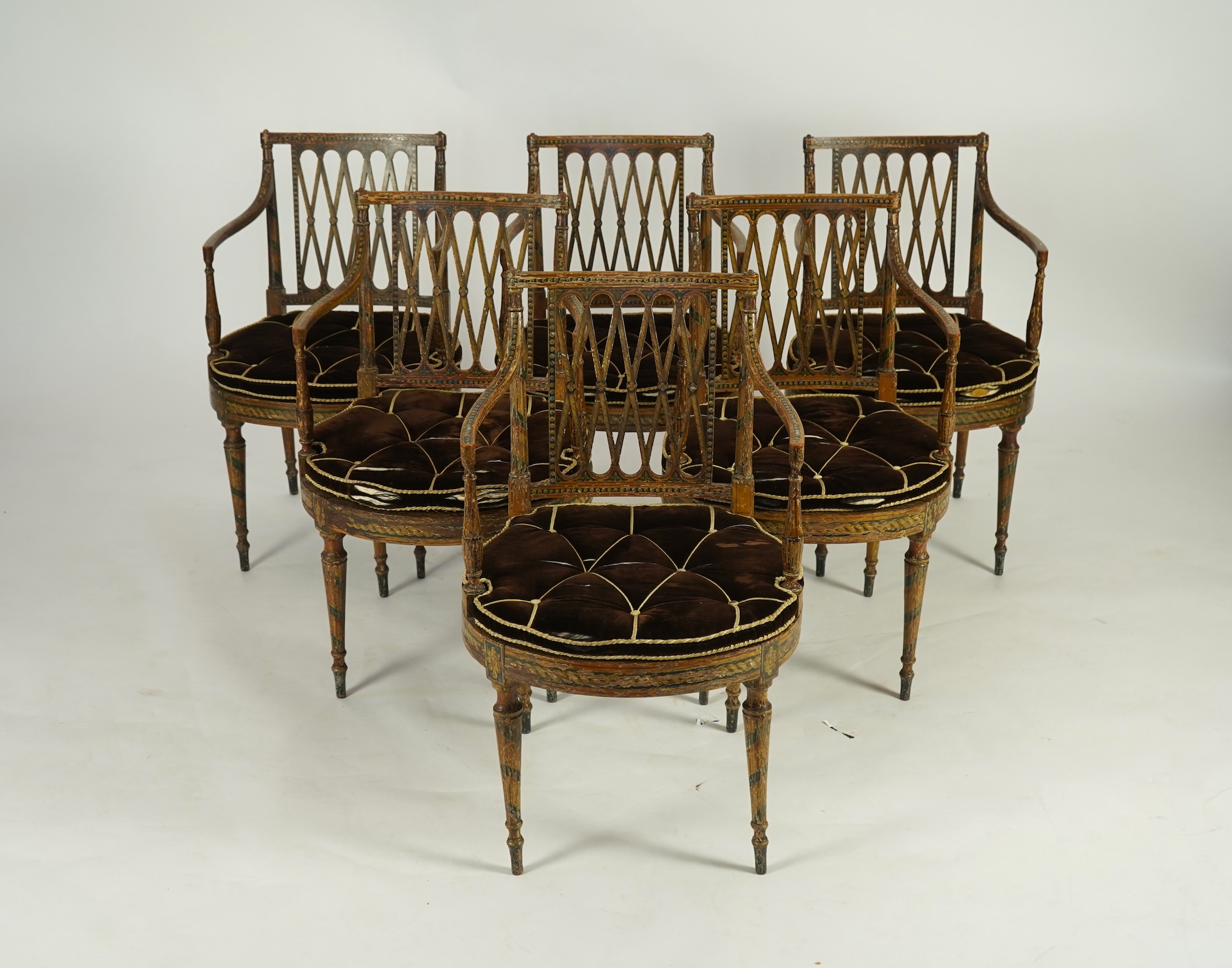 A set of six Sheraton period painted decorated cane seat elbow chairs
